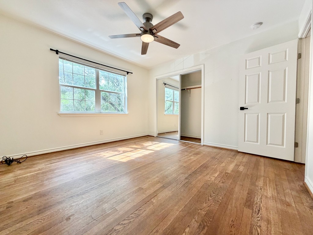 2126 Banks Street, Unit 3 Houston, TX 77098 - Photo 22 of 41 an empty room with wooden floor and windows