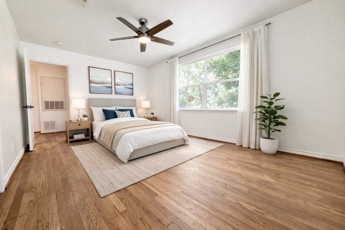 2126 Banks Street, Unit 3 Houston, TX 77098 - Photo 25 of 41 a bedroom with a large bed and a large window
