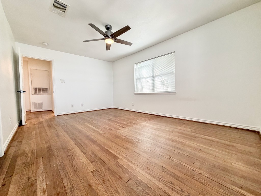 2126 Banks Street, Unit 3 Houston, TX 77098 - Photo 26 of 41 an empty room with wooden floor ceiling fan and windows