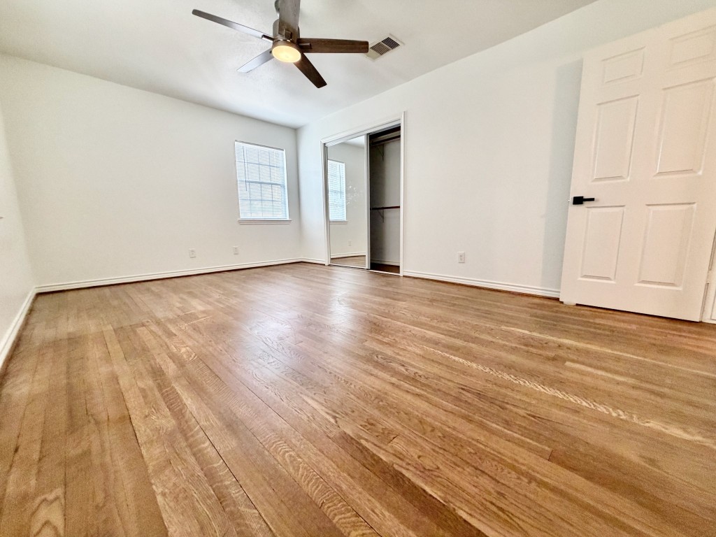 2126 Banks Street, Unit 3 Houston, TX 77098 - Photo 28 of 41 an empty room with wooden floor ceiling fan and windows