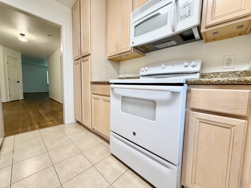 2126 Banks Street, Unit 3 Houston, TX 77098 - Photo 32 of 41 a kitchen with white cabinets and white appliances