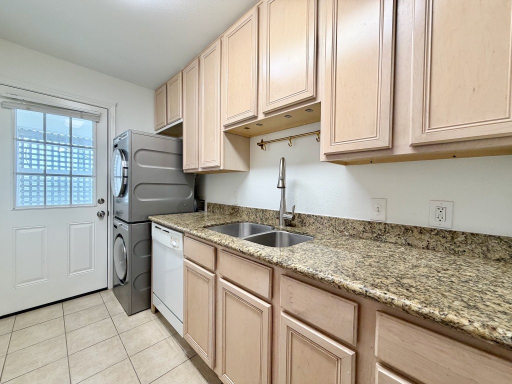 2126 Banks Street, Unit 3 Houston, TX 77098 - Photo 33 of 41 a kitchen with granite countertop a sink stainless steel appliances white cabinets and a window