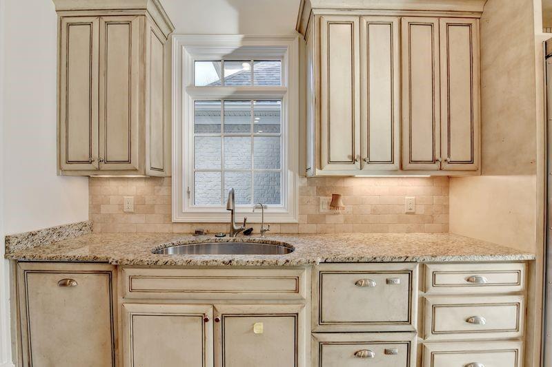 4045 Ridge Road Buford, GA 30519 - Photo 23 of 97 a kitchen with granite countertop stainless steel appliances white cabinets and a sink