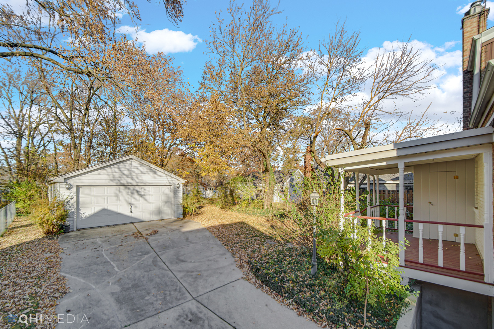 1302 Olive Road Homewood, IL 60430 - Photo 26 of 27 a backyard of a house with large trees and outdoor seating