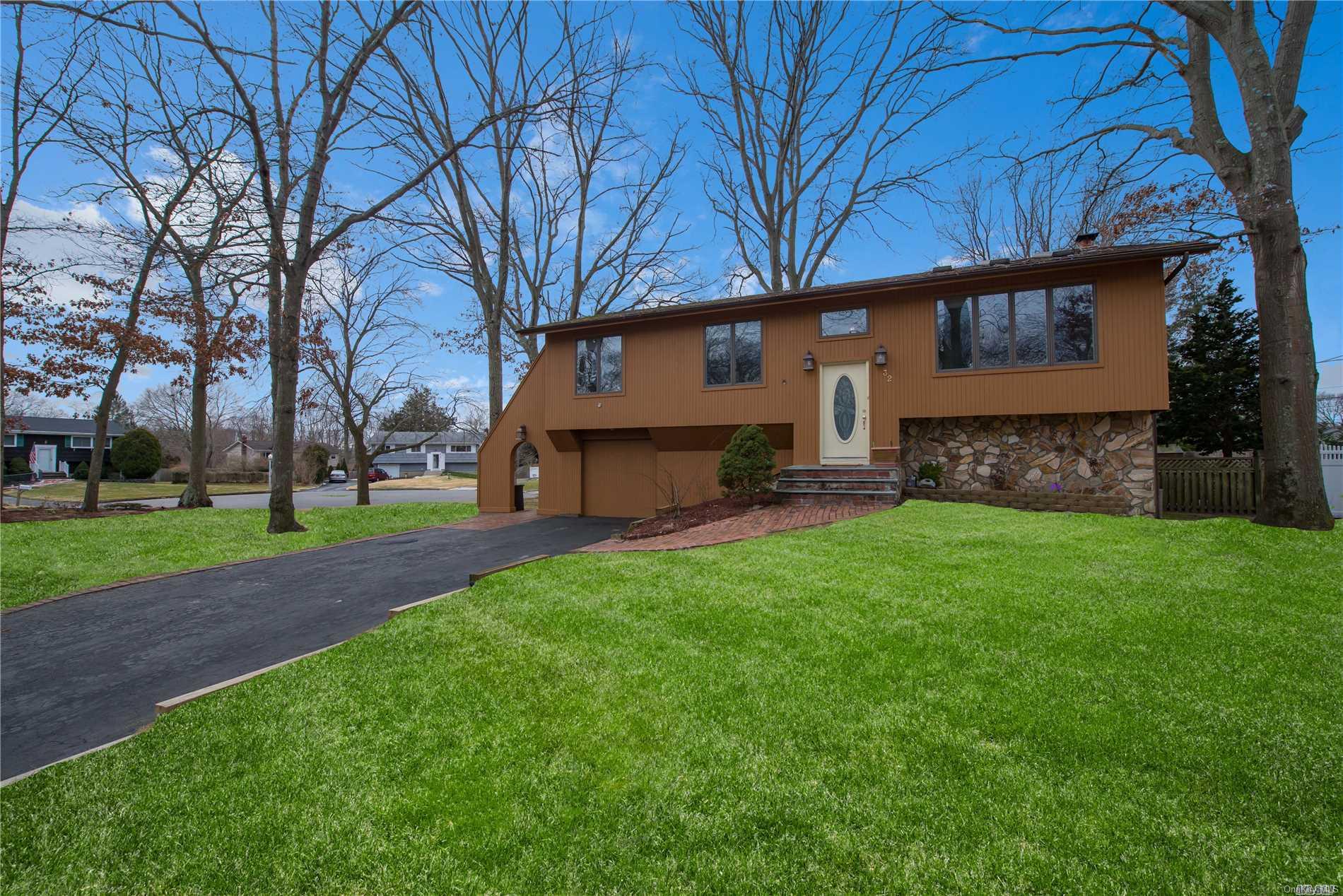 a front view of house with yard and green space