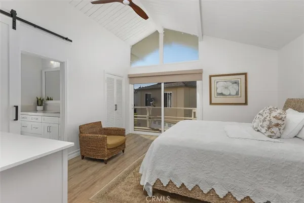 a bedroom with a bed and glass window