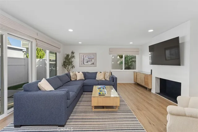 a living room with fireplace furniture and a flat screen tv
