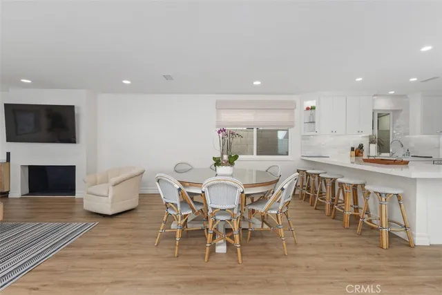 a view of a dining room with furniture wooden floor and a fireplace