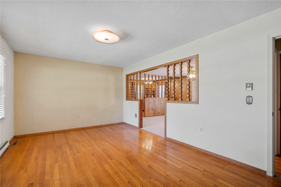 2101 Old Spring Drive Anderson, SC 29625 - Photo 3 of 36 Natural hardwood flooring guides you through this ample living space, featuring an inviting wooden room divider.