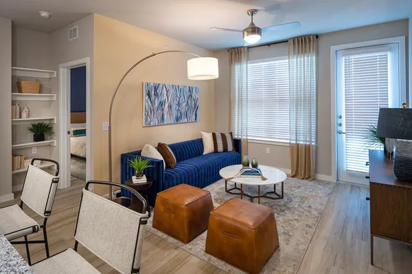 a living room with furniture and wooden floor