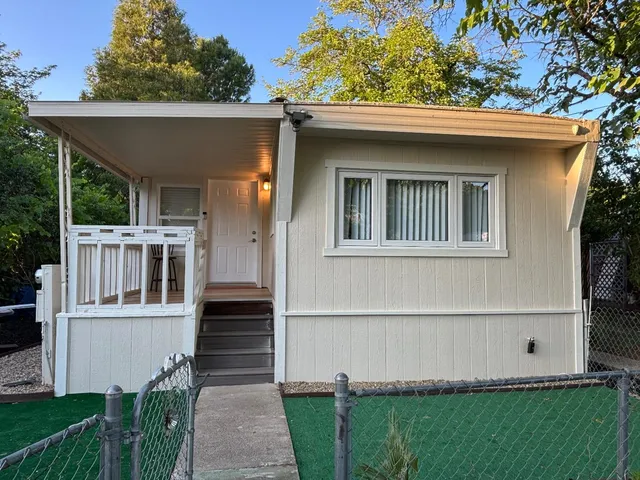 a front view of a house with a garden