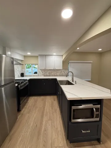 a kitchen with a stove sink and a refrigerator