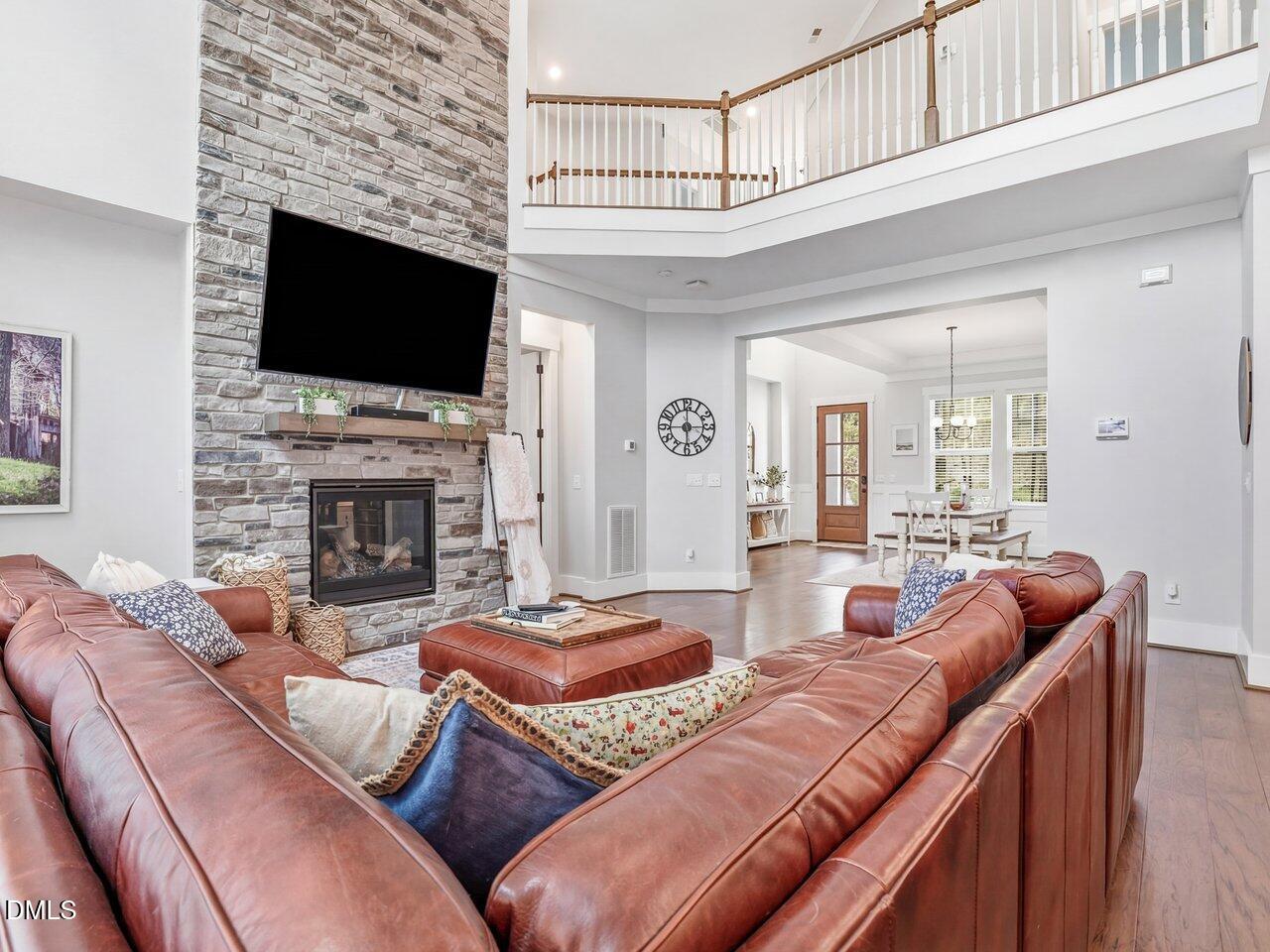 36 Nuthatch Pittsboro, NC 27312 - Photo 22 of 66 a living room with furniture a flat screen tv and a fireplace
