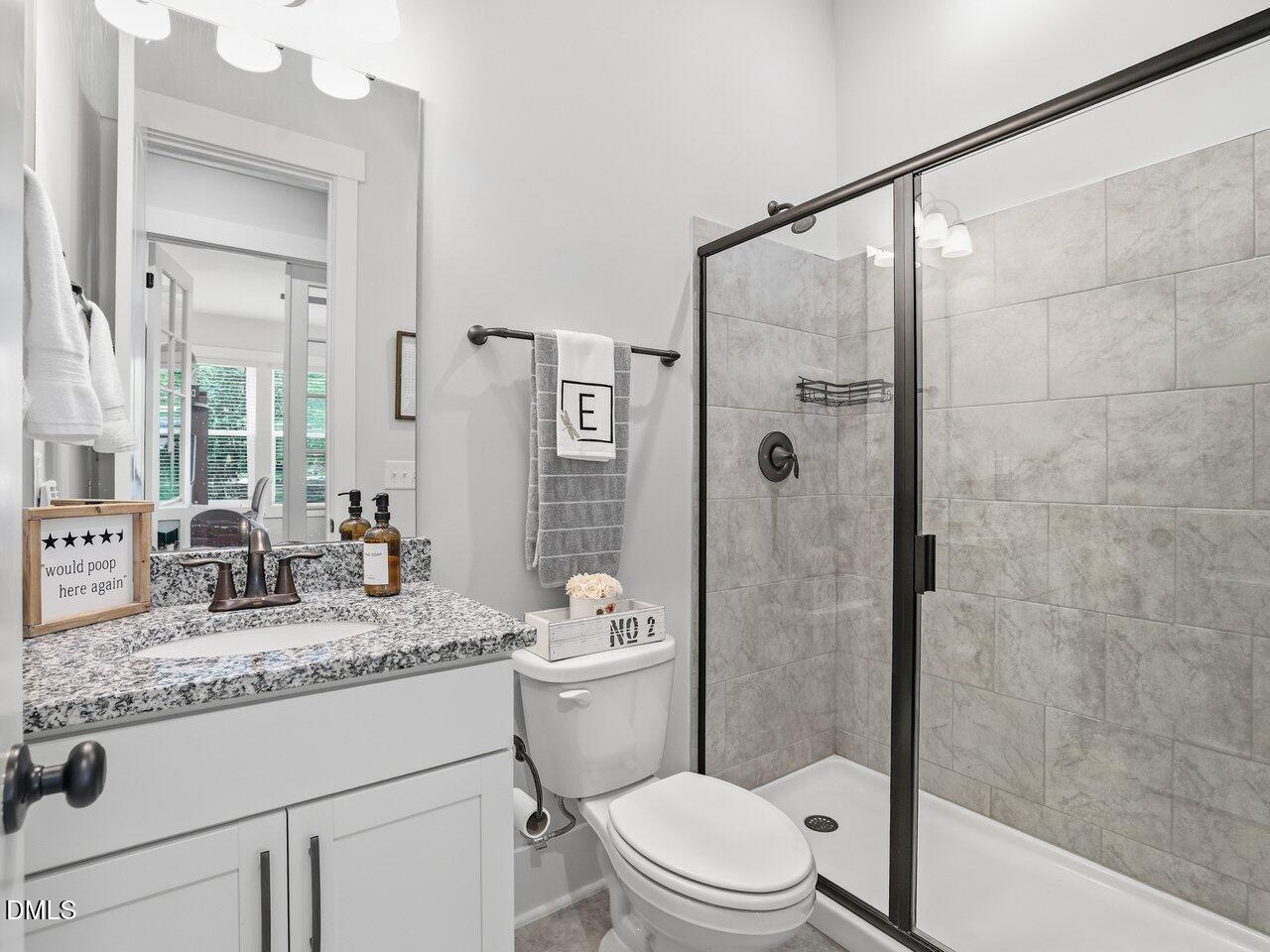 36 Nuthatch Pittsboro, NC 27312 - Photo 34 of 66 a bathroom with a granite countertop sink a mirror a toilet and shower