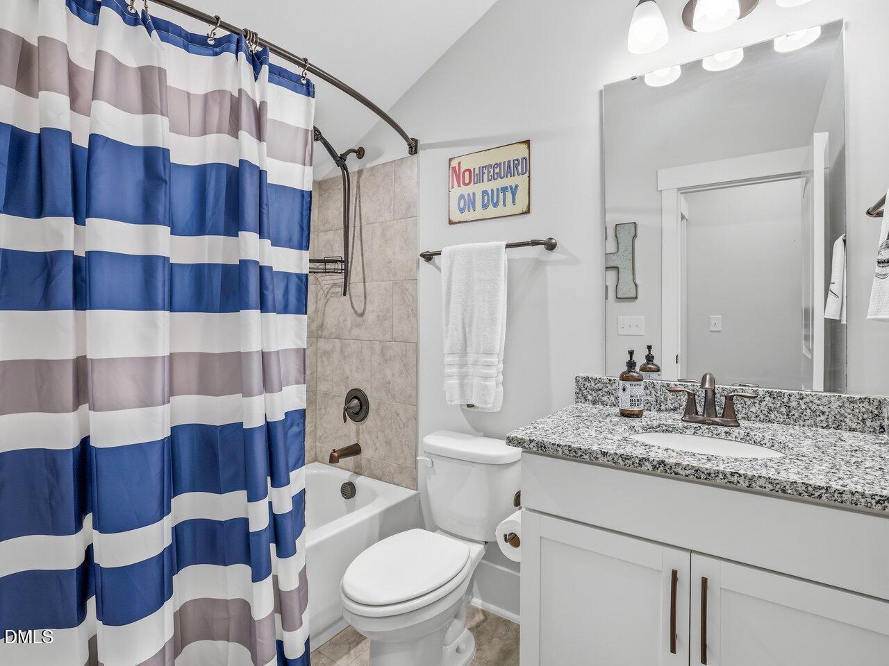 36 Nuthatch Pittsboro, NC 27312 - Photo 44 of 66 a bathroom with a sink a toilet a mirror and shower curtain