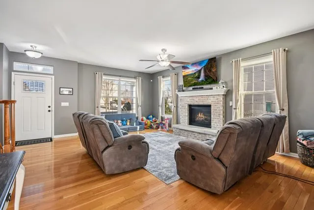 a living room with furniture flat screen tv and a fireplace