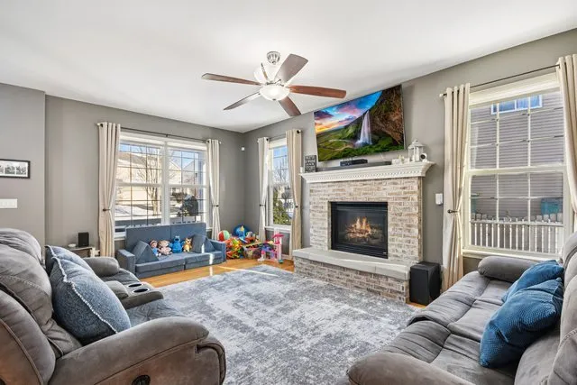 a living room with furniture a fireplace and a flat screen tv