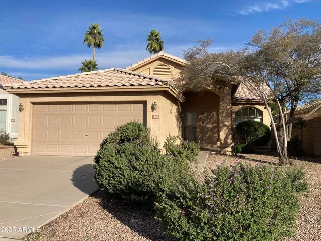 a view of a house with a yard and plants
