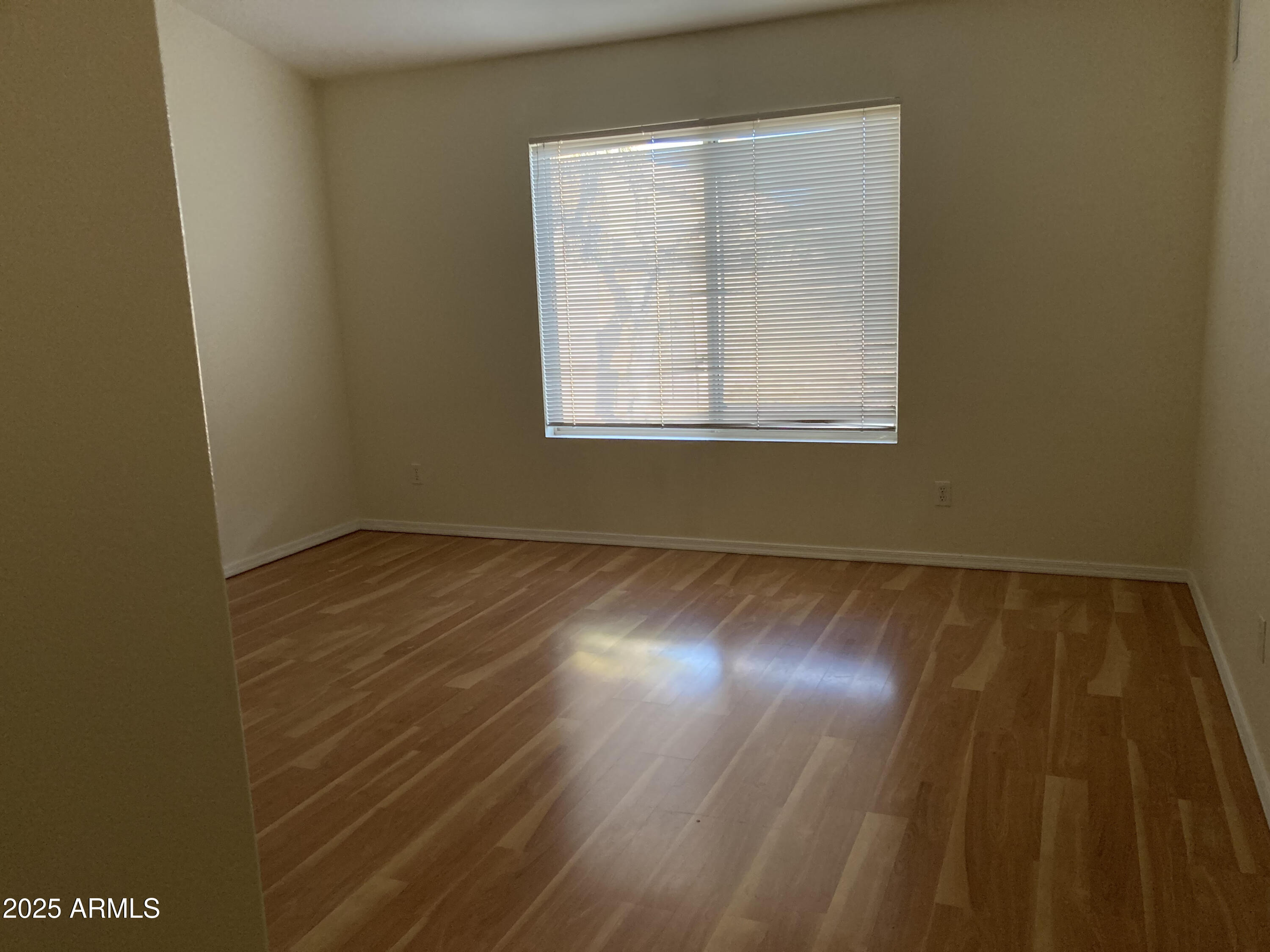 436 West Bolero Drive Tempe, AZ 85284 - Photo 9 of 11 an empty room with wooden floor and windows