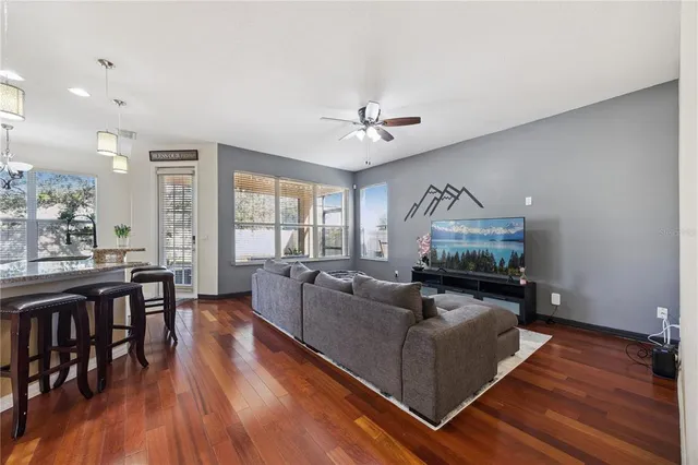 a living room with furniture and a wooden floor