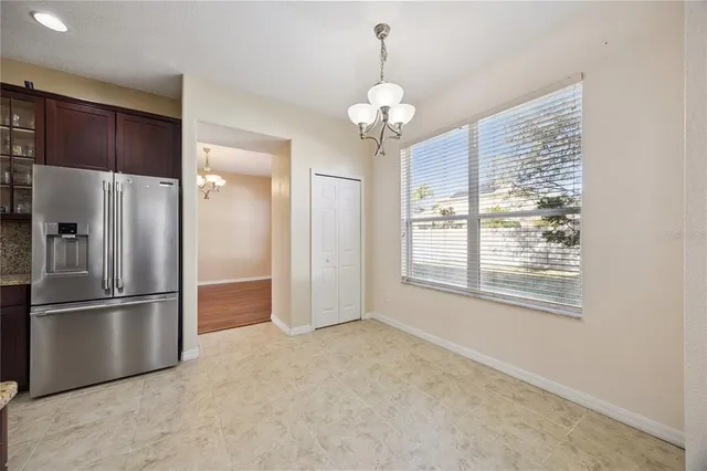 a large kitchen with stainless steel appliances lots of counter space and a refrigerator