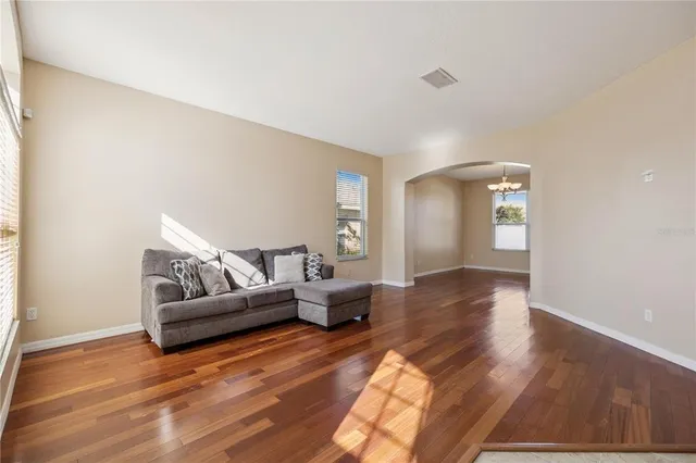 a living room with furniture and wooden floor