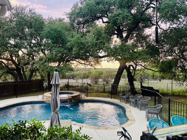 a view of a swimming pool with a patio