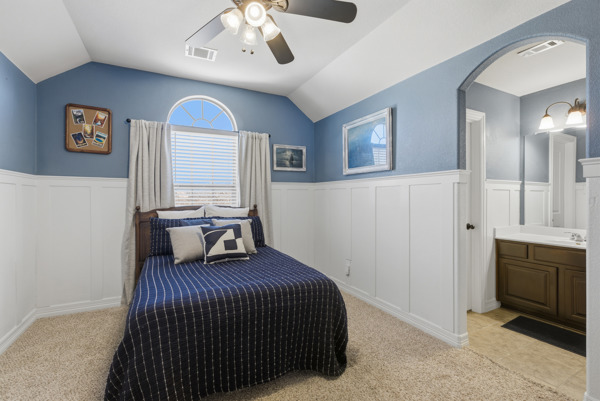 464 Monahans Drive Georgetown, TX 78628 - Photo 25 of 39 a bedroom with a bed and a chandelier