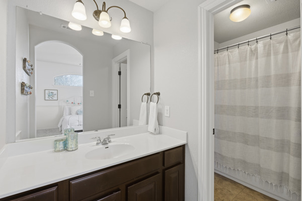 464 Monahans Drive Georgetown, TX 78628 - Photo 27 of 39 a bathroom with a sink a light fixture and a mirror