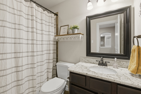 464 Monahans Drive Georgetown, TX 78628 - Photo 29 of 39 a bathroom with a granite countertop sink toilet and mirror