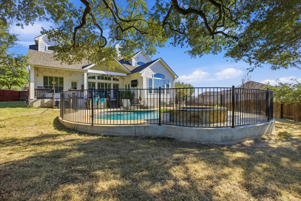464 Monahans Drive Georgetown, TX 78628 - Photo 36 of 39 a view of a house with a wooden deck and a yard with trees