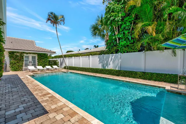 a view of a patio with table and chairs with wooden fence and plants