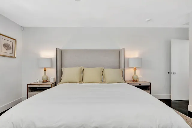 a living room with furniture a flat screen tv and a large window