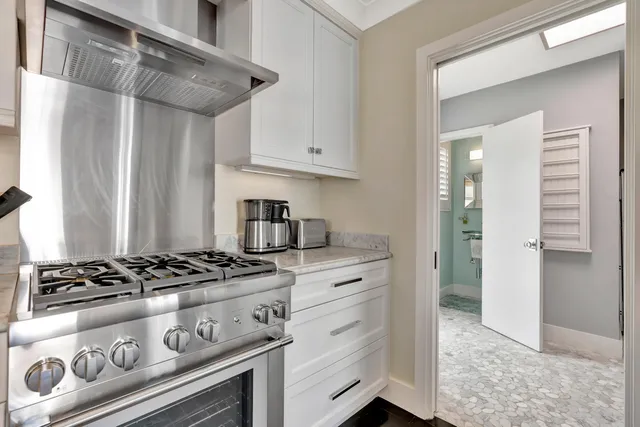 a living room with furniture a mirror and a table