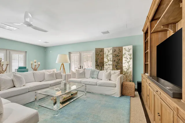 a living room with furniture and a baby crib