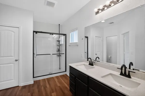 a bathroom with a sink double vanity and a mirror
