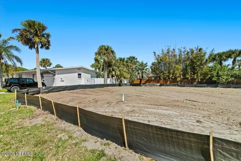 a view of a swimming pool with a lawn chairs under an umbrella