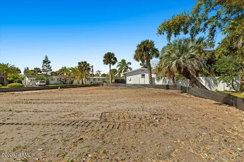 a view of dirt yard with a large tree