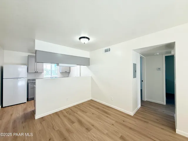 a view of a kitchen with wooden floor