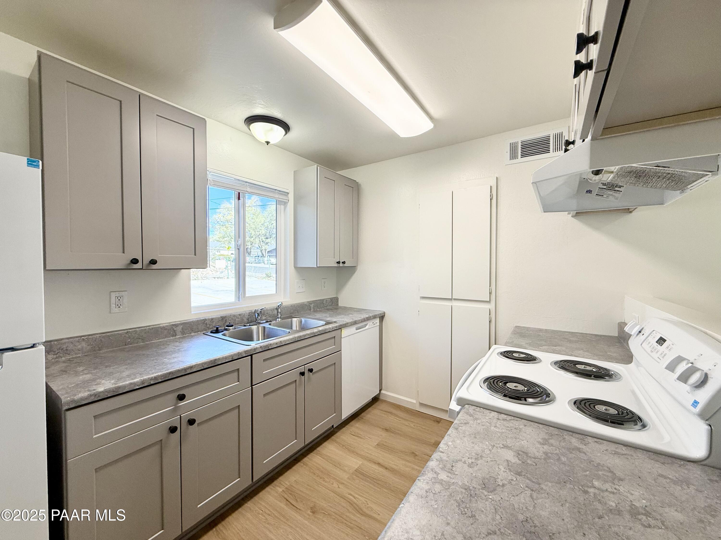 564 Lincoln Avenue, Unit B Prescott, AZ 86301 - Photo 3 of 11 a kitchen with a sink a stove and cabinets