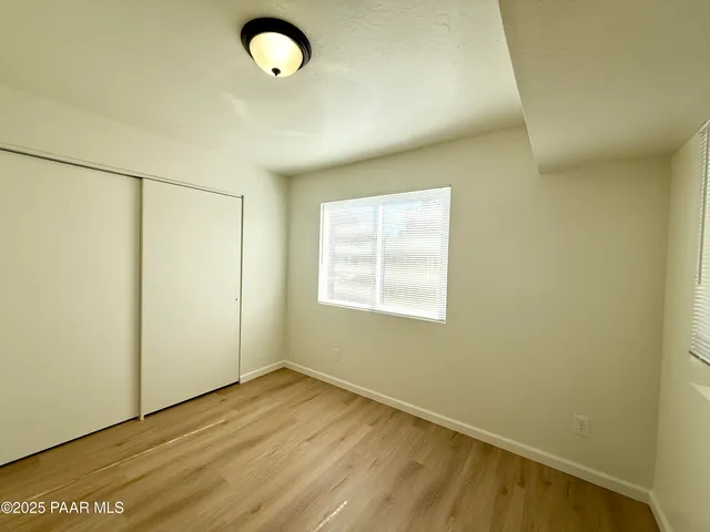 a view of a room with wooden floor and white walls
