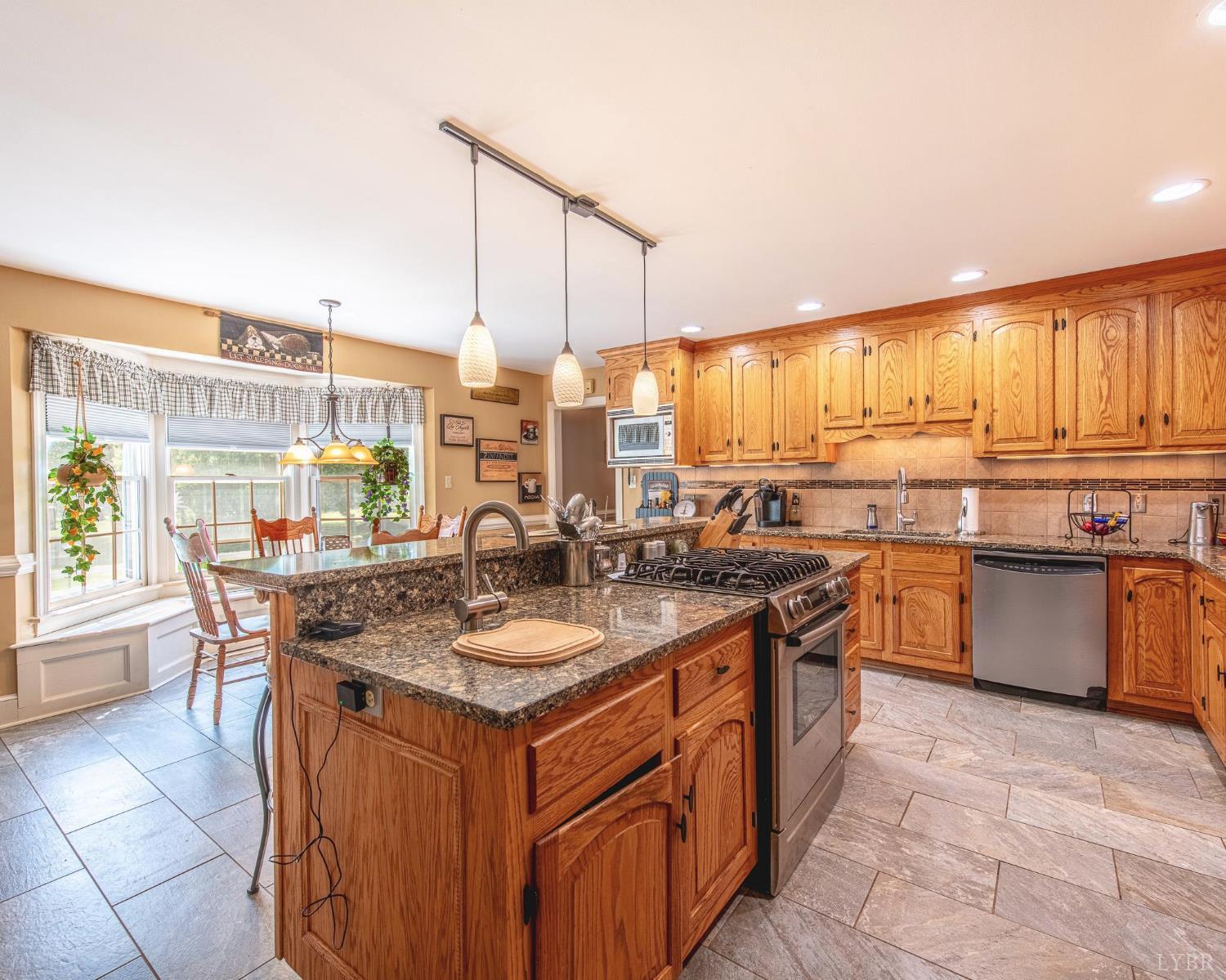 2667 Union Church Road Gladstone, VA 24553 - Photo 16 of 75 a kitchen with kitchen island granite countertop a sink counter top space and stainless steel appliances