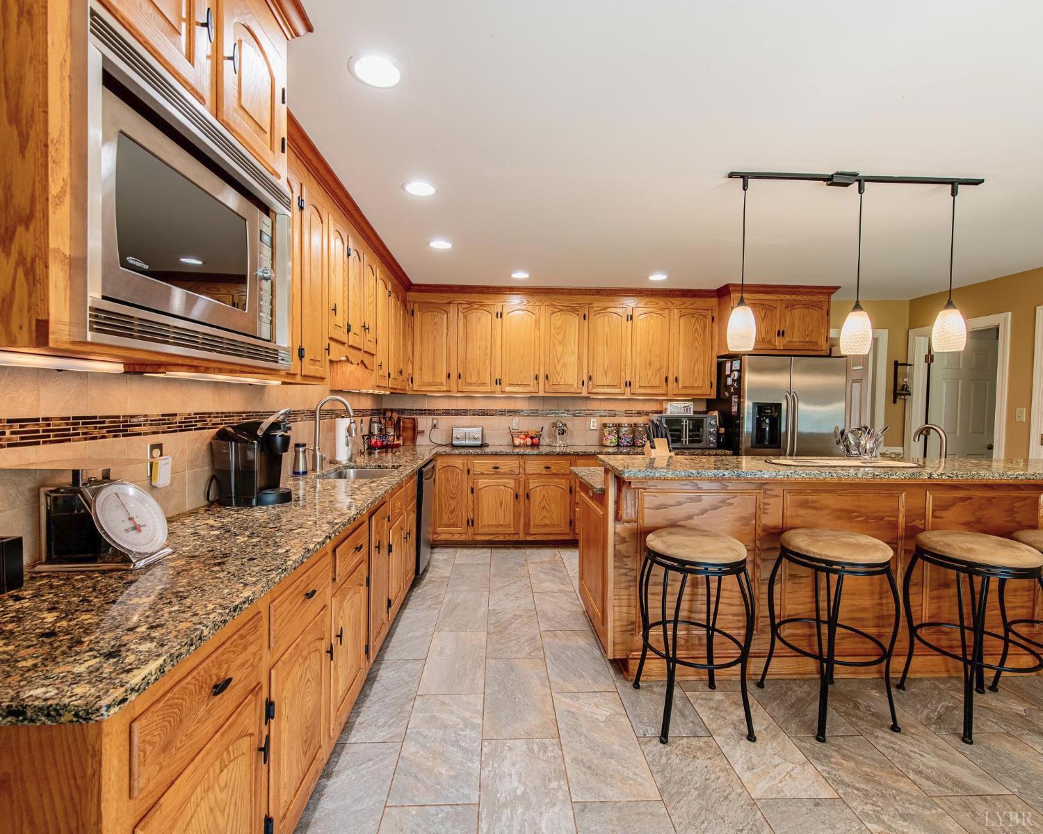 2667 Union Church Road Gladstone, VA 24553 - Photo 18 of 75 a kitchen with stainless steel appliances kitchen island granite countertop a sink and cabinets