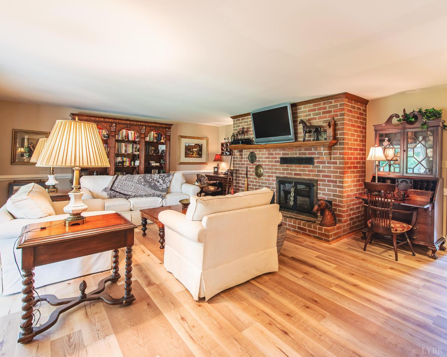 2667 Union Church Road Gladstone, VA 24553 - Photo 24 of 75 a living room with furniture a fireplace and a flat screen tv