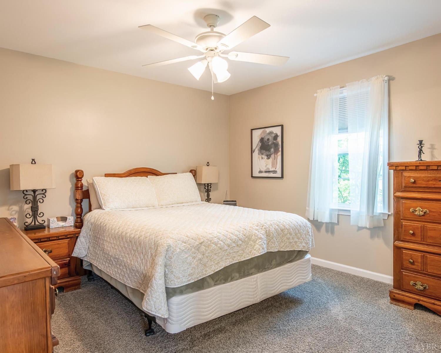 2667 Union Church Road Gladstone, VA 24553 - Photo 72 of 75 a bedroom with a bed and a chandelier