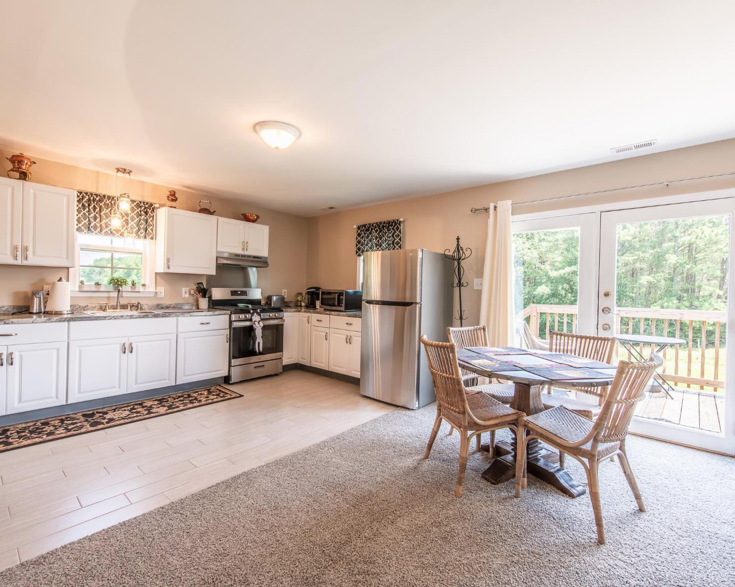 2667 Union Church Road Gladstone, VA 24553 - Photo 74 of 75 a kitchen with stainless steel appliances kitchen island granite countertop a table and chairs in it