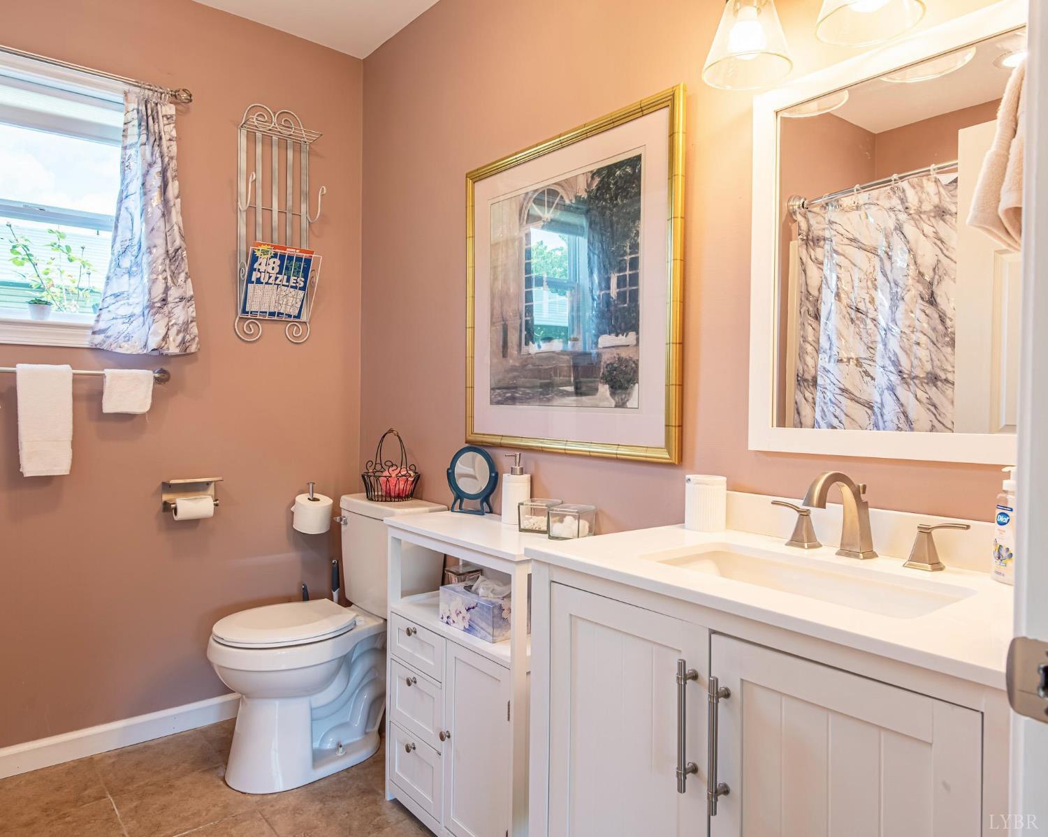 2667 Union Church Road Gladstone, VA 24553 - Photo 75 of 75 a bathroom with a toilet sink and mirror