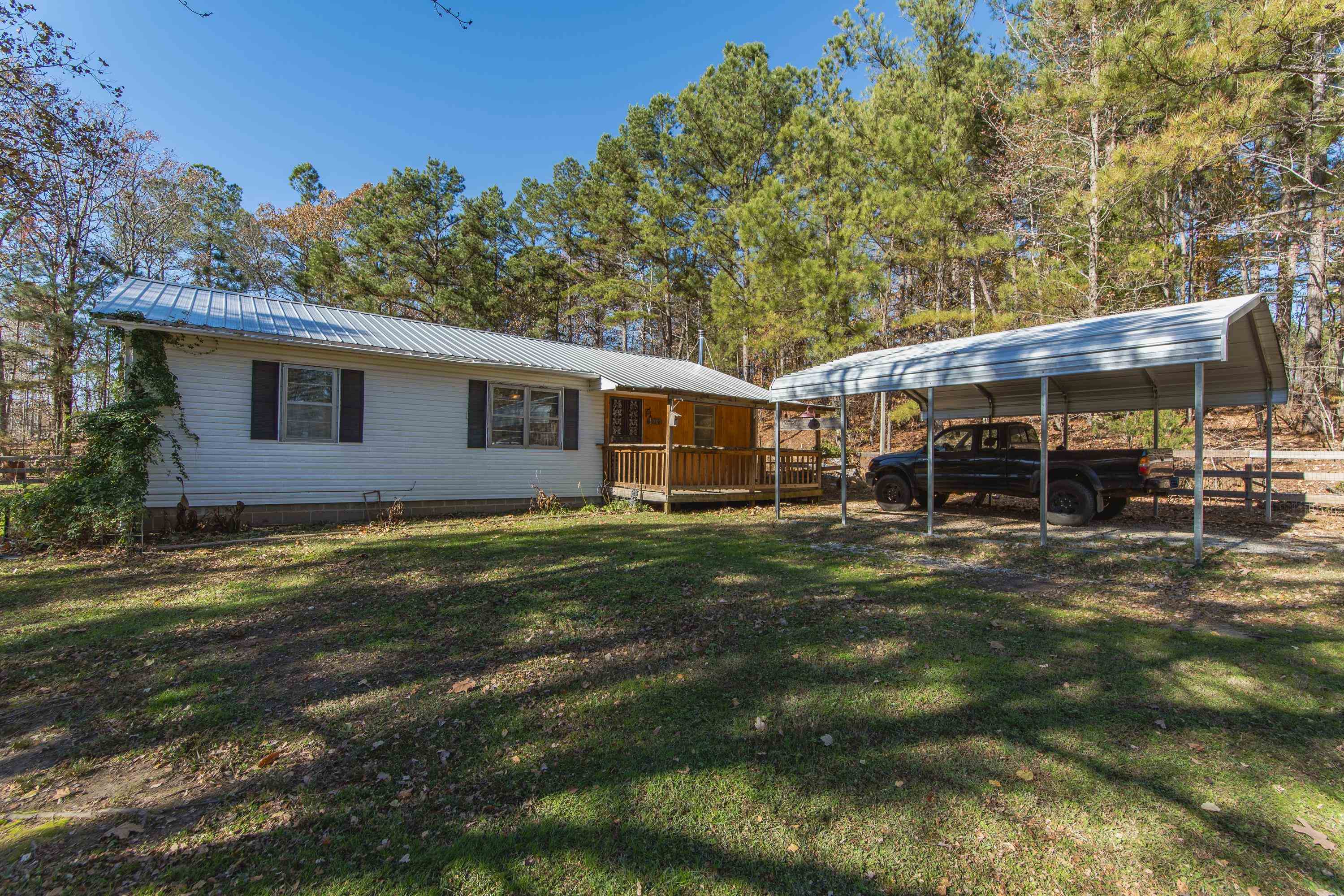 3001 Hamilton Road Ashland, MS 38603 - Photo 31 of 39 Back of property featuring a carport, a wooden deck, and a lawn