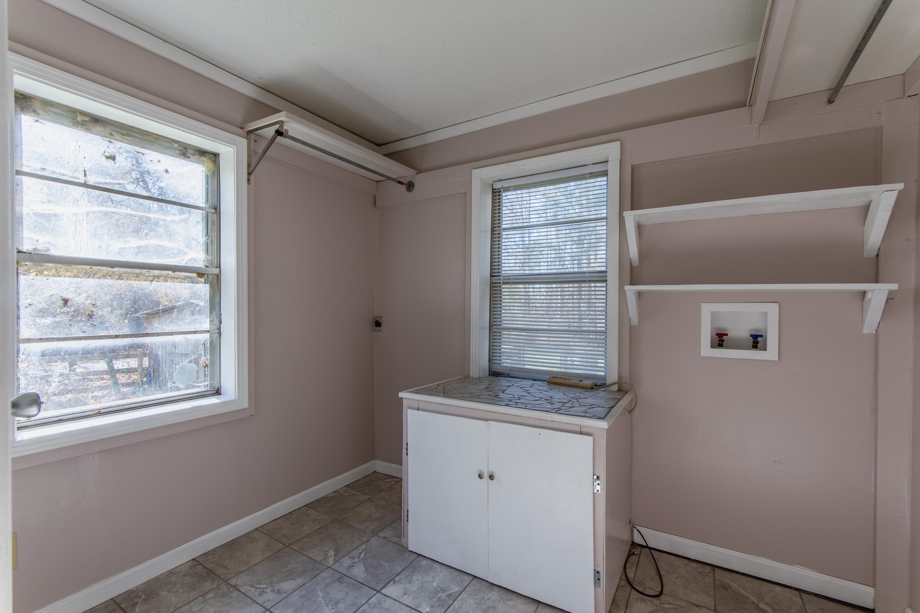 3001 Hamilton Road Ashland, MS 38603 - Photo 6 of 39 Laundry area with hookup for a washing machine, light tile patterned floors, and cabinets