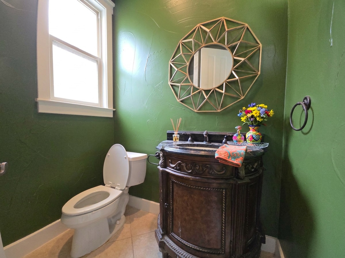 2800 Waymaker Way, Unit 24 Austin, TX 78746 - Photo 8 of 14 Ornate dark wood vanity with an integrated basin and a dark countertop